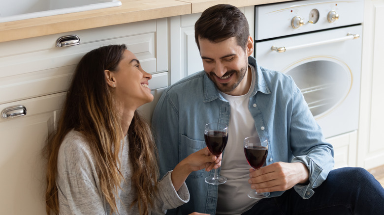 Couple drinking wine in kitchen