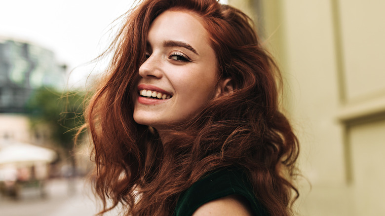 smiling woman with curly red hair