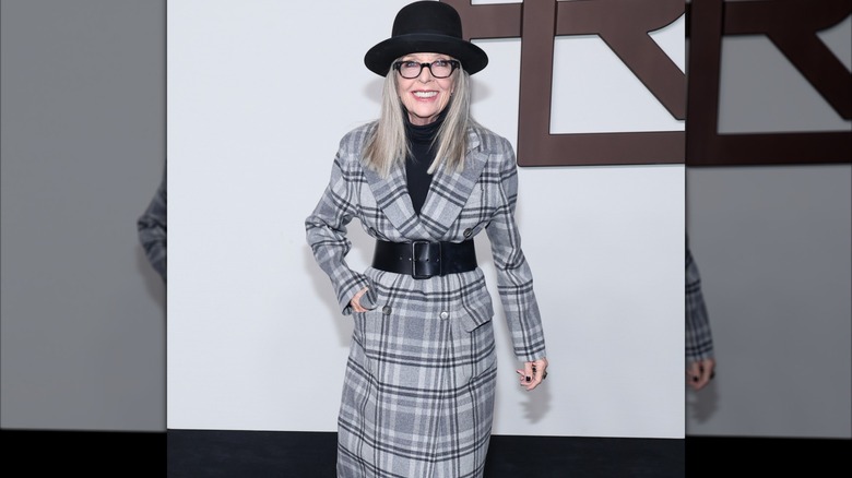 Diane Keaton in a gray plaid coat and black hat