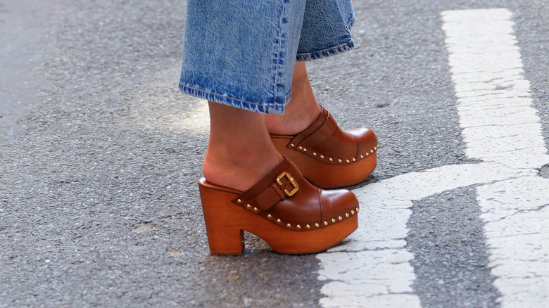 Tan 1970s-style clogs on woman's feet