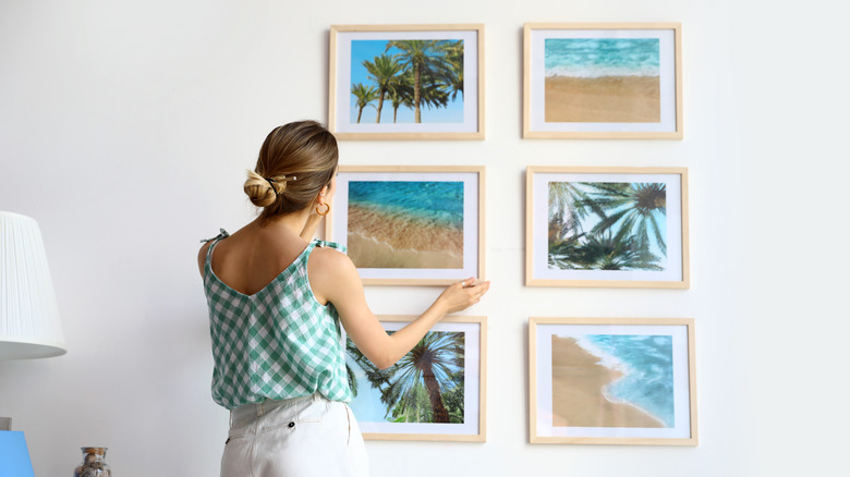 person arranging a gallery wall