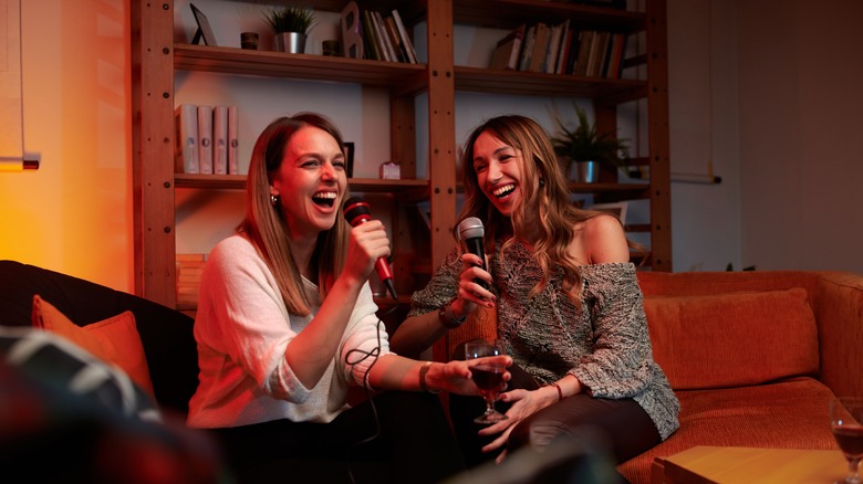 Two women singing karaoke