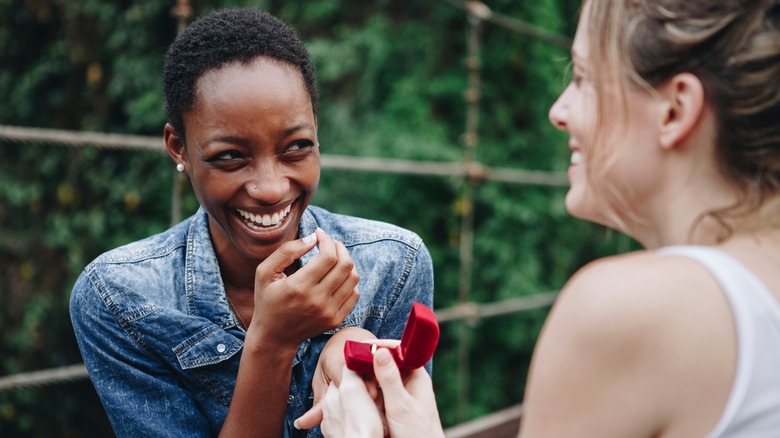 woman proposing with ring