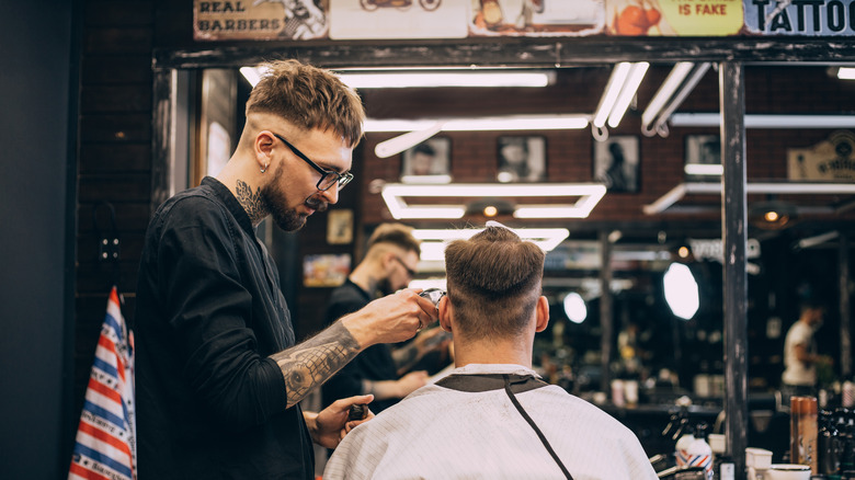 barber cutting client's hair