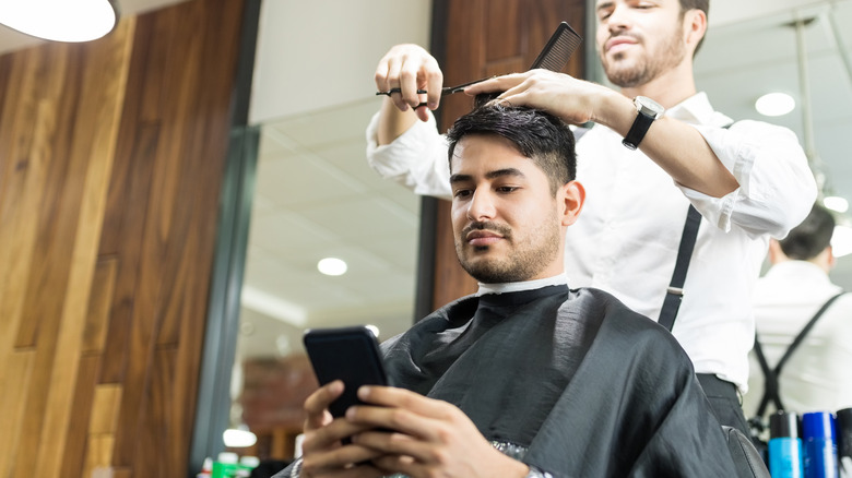 client on phone in salon