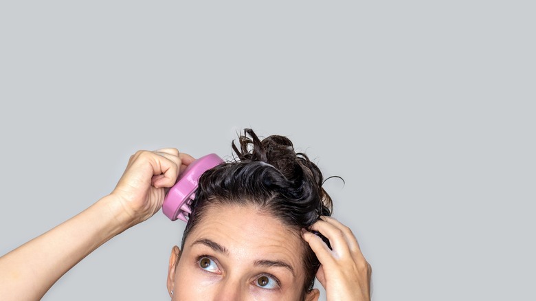 woman using a scalp massager