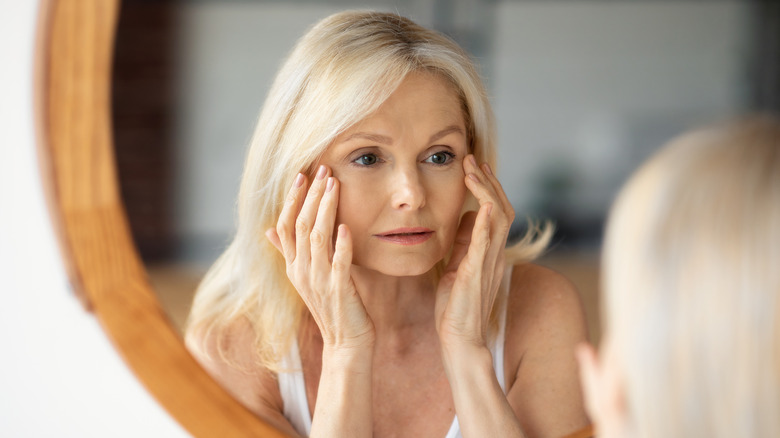 Woman looking herself at mirror