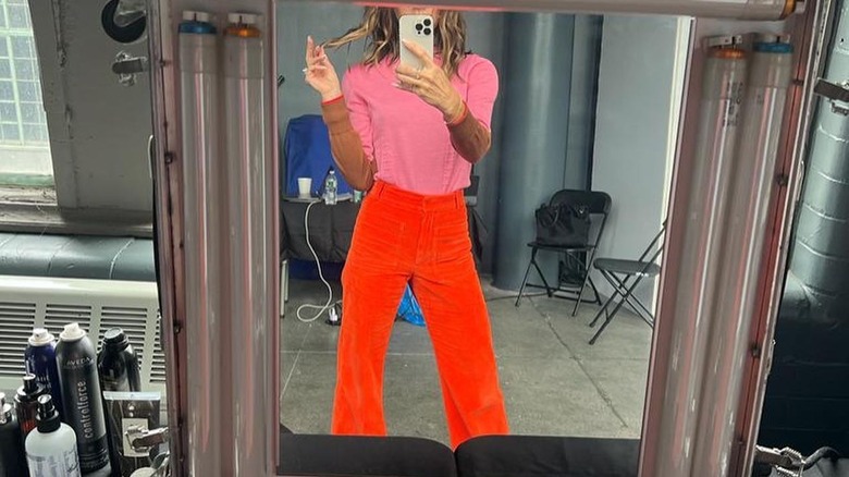 Victoria Beckham wearing pink and orange