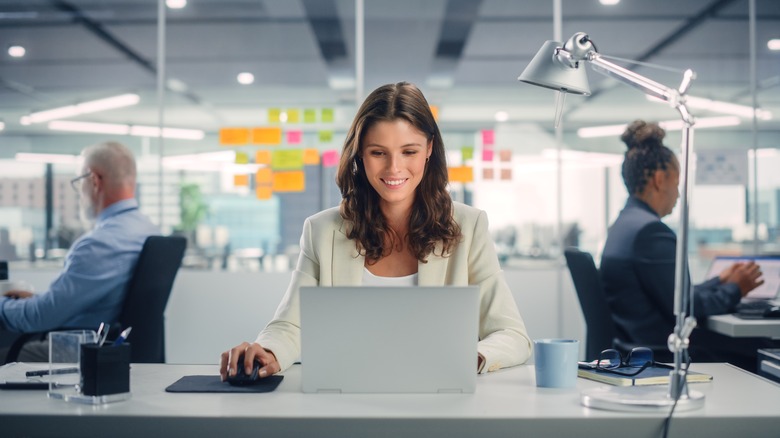 woman working in an office on her computer