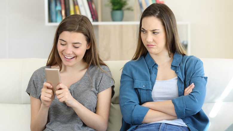 Woman on phone, friend angry