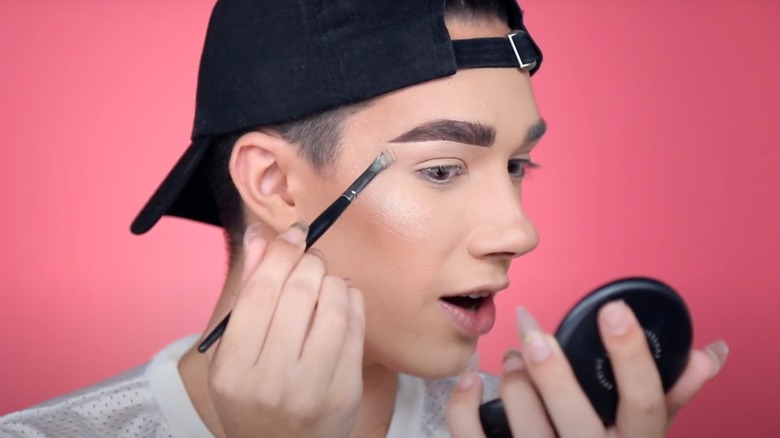 James Charles doing eyebrow tutorial