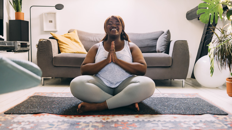 smiling woman on yoga mat