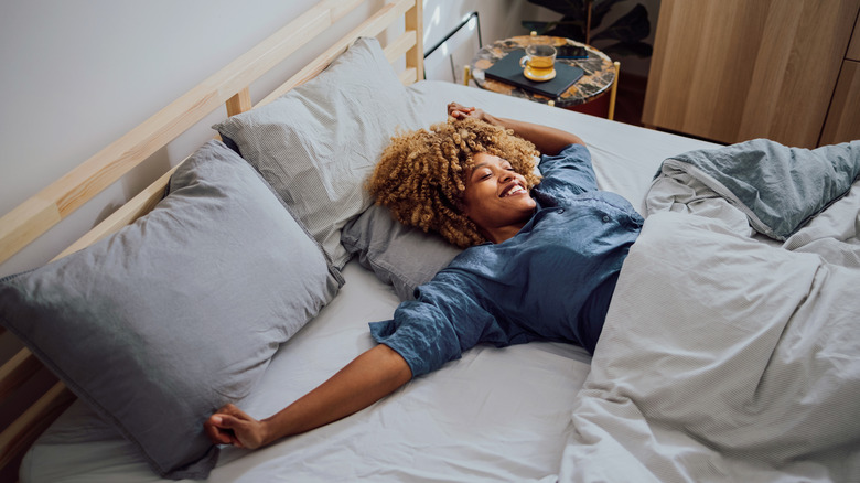 woman stretching in bed