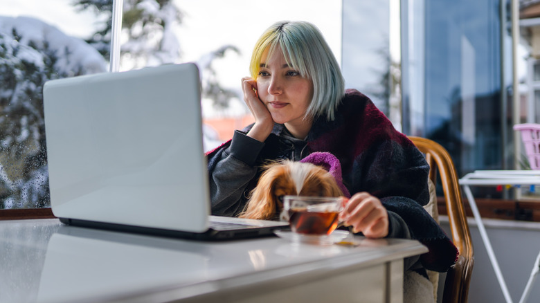 woman using laptop on balcony