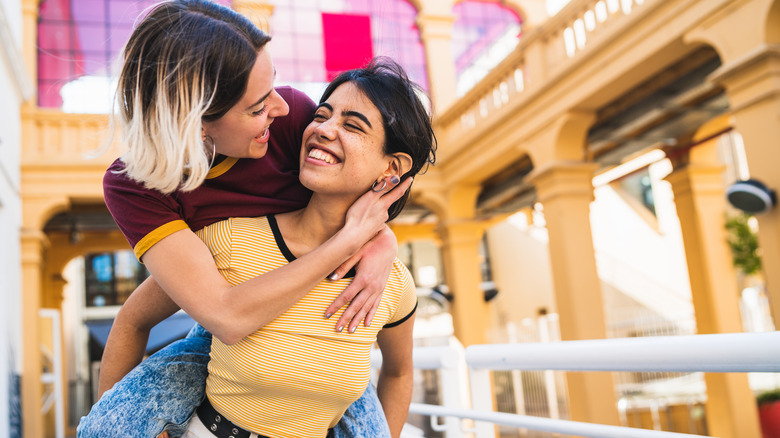 Smiling women acting affectionate