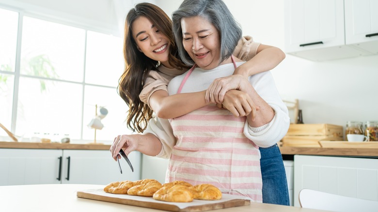 Mother and daughter baking together