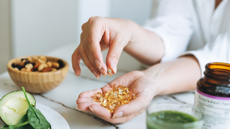 Woman holding handful of vitamins