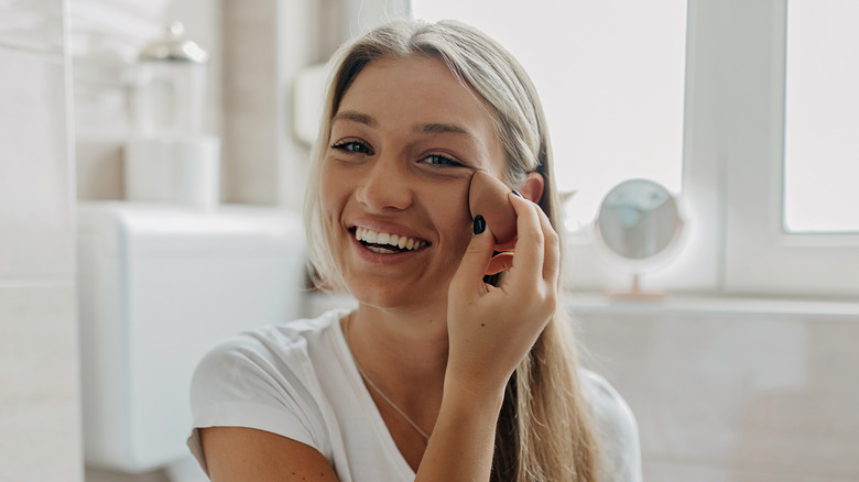 Woman putting on makeup