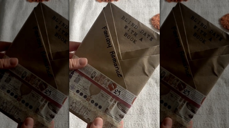 person holding wrapped book