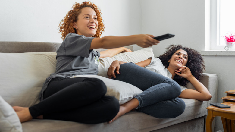 smiling women watching TV