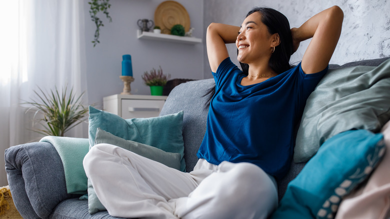 smiling woman resting on sofa