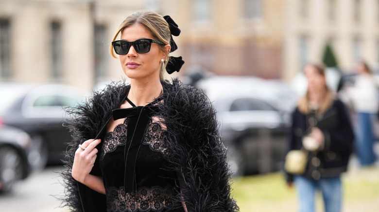 Woman in black lace top and fur wrap