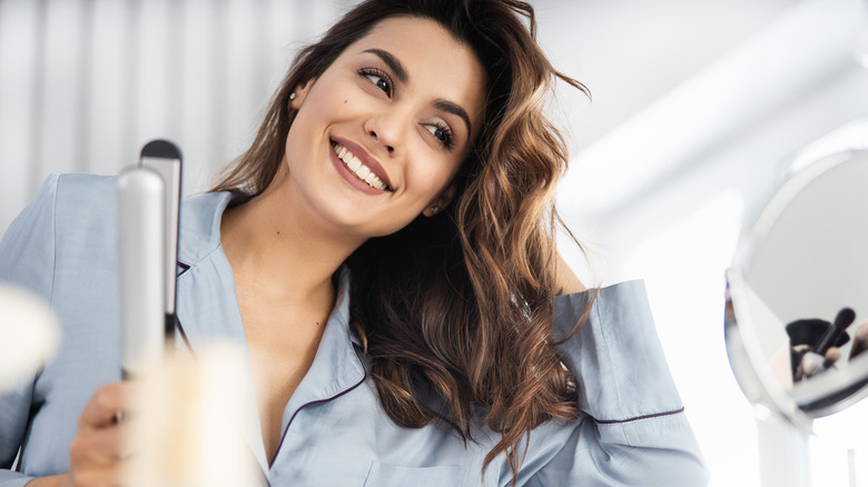 Woman styling her hair 