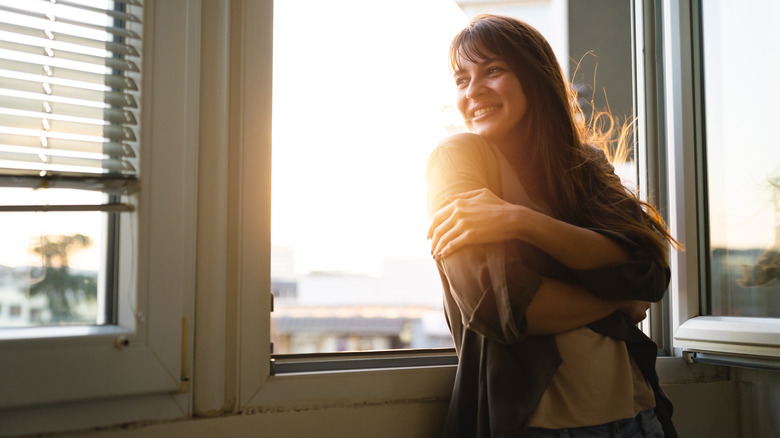 smiling woman near window