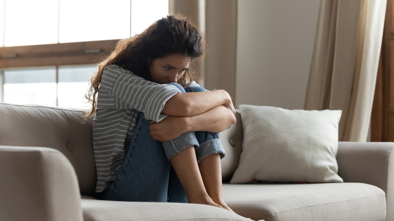 Sad woman on couch