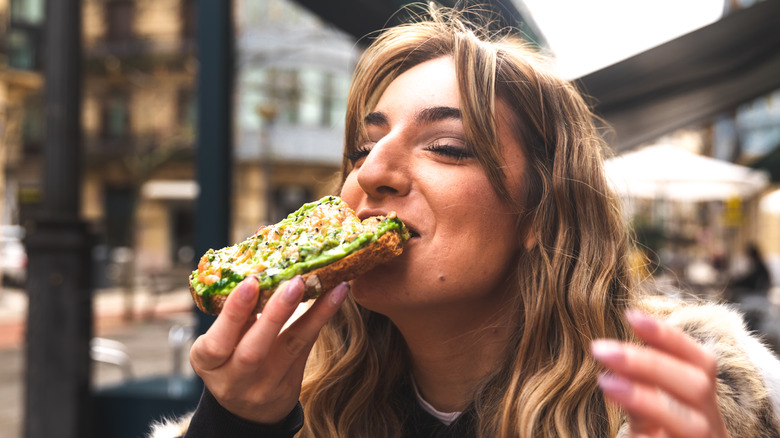 person eating avocado toast