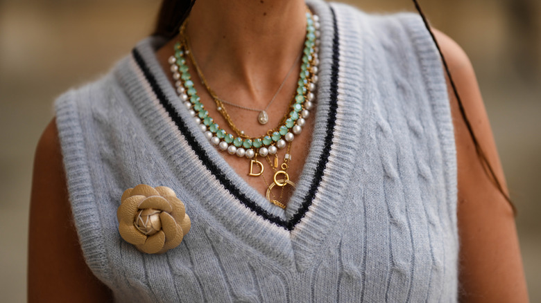 Woman wearing multiple layers of necklaces