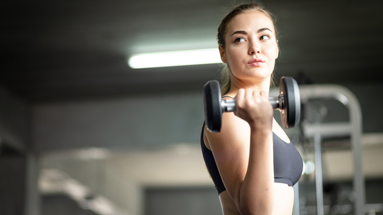 Woman flexing with weight