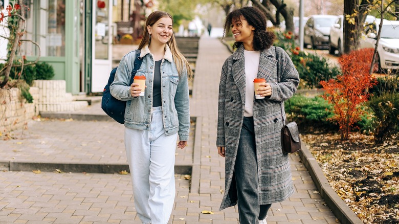 women walking with coffee cups