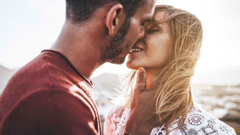 Couple kisses on beach