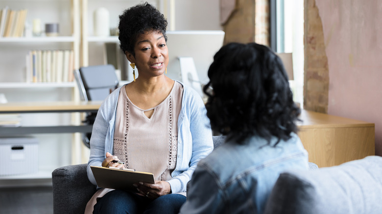 Therapist talking to patient