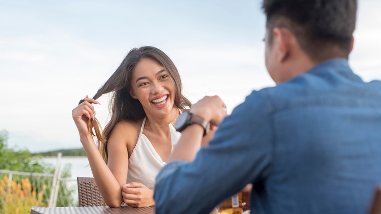 Couple meets for drink on outdoor patio 