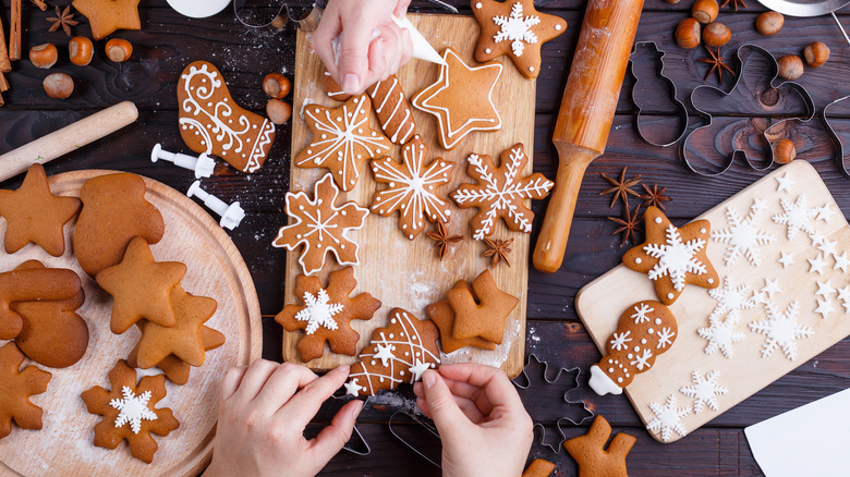 People icing gingerbread cookies