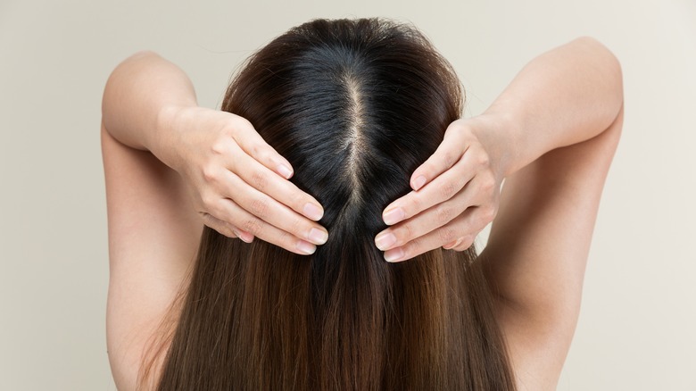 Person parting their hair with both hands