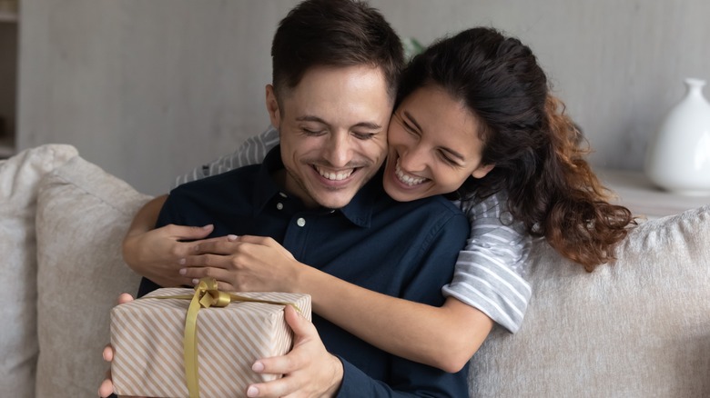 woman giving man a gift