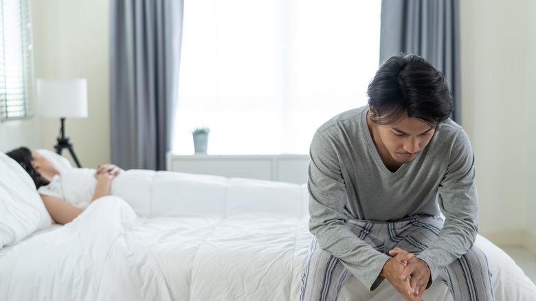 sad man sitting in bed  