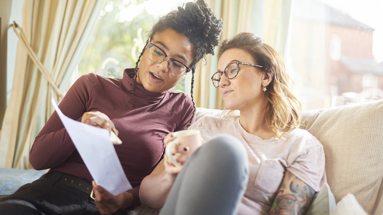 women with paper talking