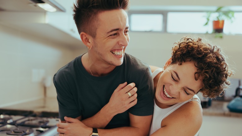 couple in kitchen laughing