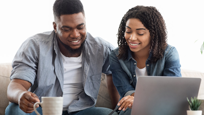 couple with laptop and paper