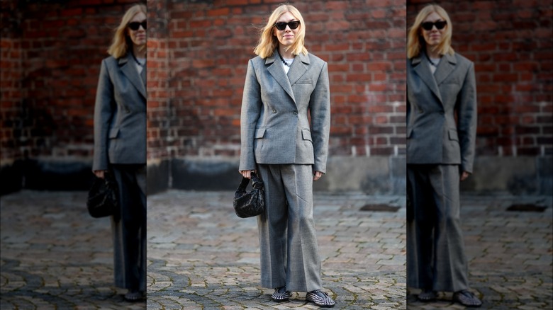 woman wearing a grey pantsuit