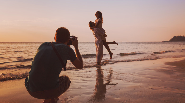 photographer takes picture of a couple