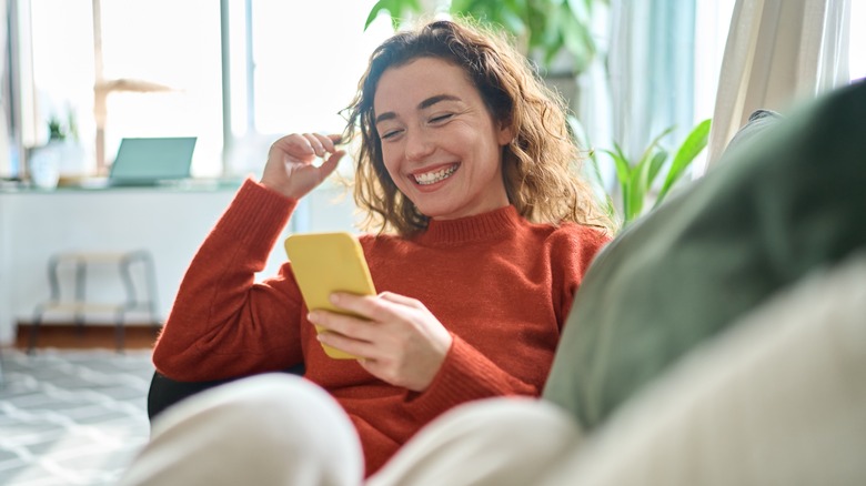 woman happy looking at phone