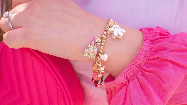 Disney-themed charm bracelet on a wrist