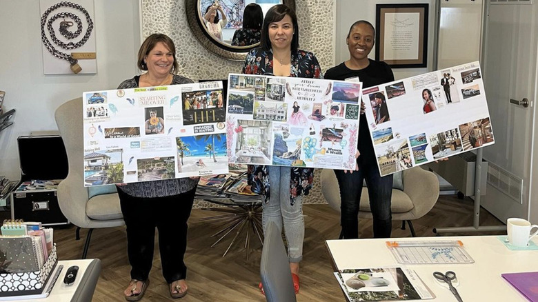 women holding vision boards