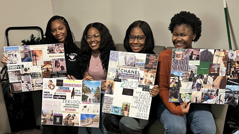 women holding vision boards
