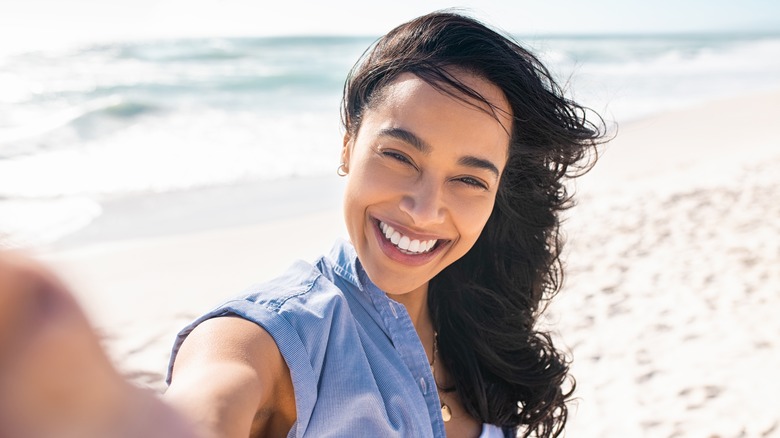 woman taking selfie at the beach